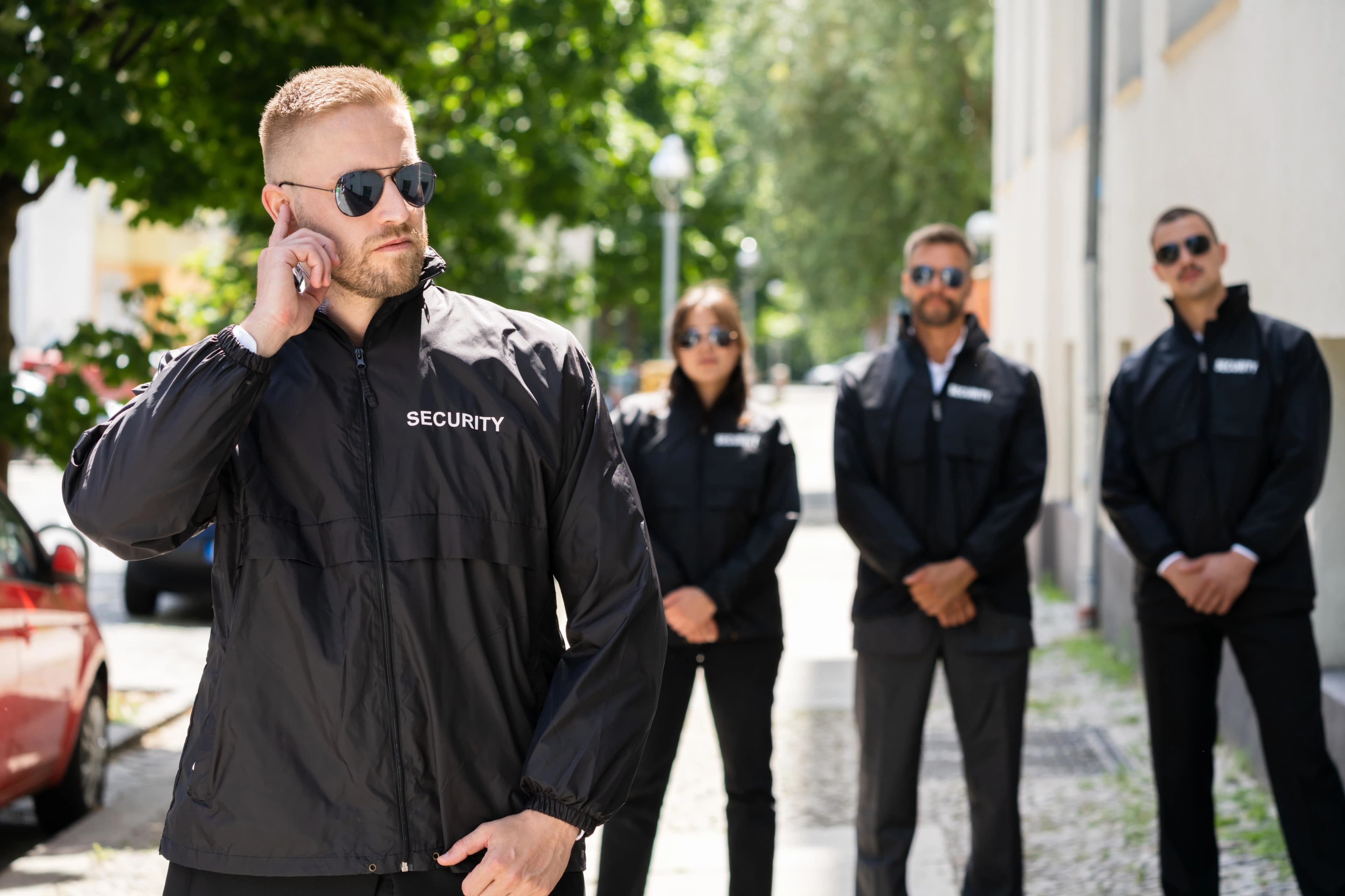 Security team in branded jackets providing manned guarding on a London street