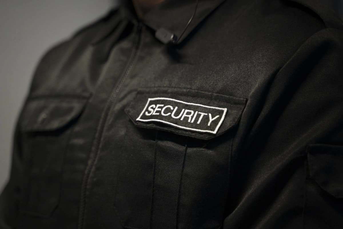 Security officer in black uniform with embroidered SECURITY patch in London
